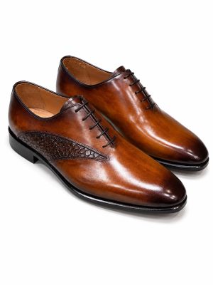 Chaussures Richelieu Jespomi marron cognac en cuir patiné avec empiècement effet croco sur le côté et finition élégante brillante.